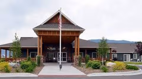 Exterior view of Timber Creek Village Assisted Living of Lincoln entrance with landscaping.