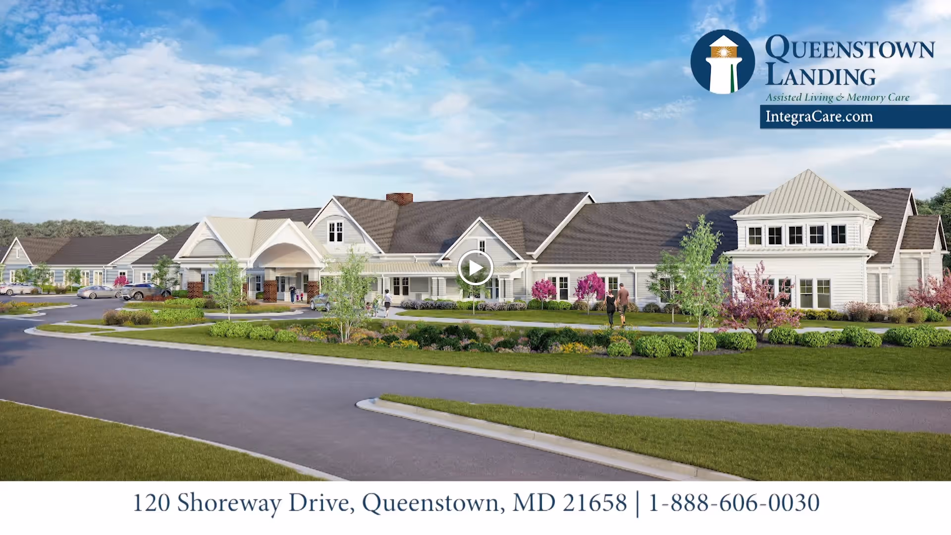Front exterior of Queenstown Landing senior living facility with landscaped grounds and driveway under a blue sky.