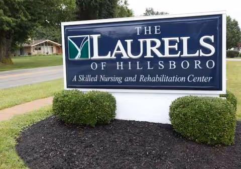 Front exterior sign displays 'The Laurels of Hillsboro' with landscaping.