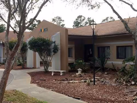 Exterior view of Worc Haven front entrance with walkway, sign, and landscaping.