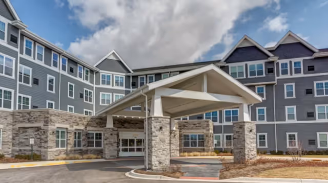 Exterior view of Alto Wheaton senior living building with a covered entrance canopy.