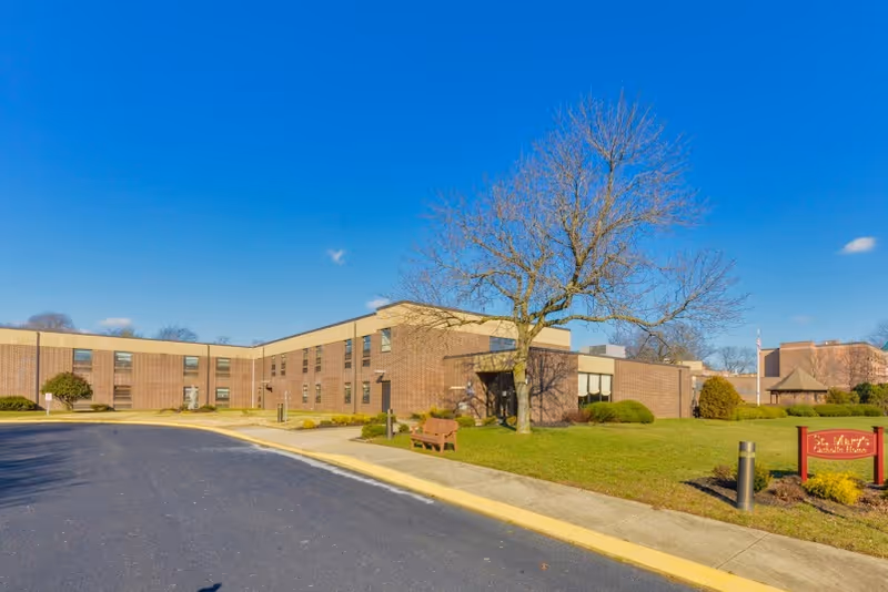 Exterior view of St. Mary's Center for Rehabilitation and Healthcare building under a clear blue sky.