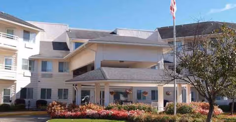 Exterior view of Asher Point Independent Living of Montgomery, showing entrance and landscaping.