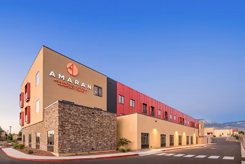 The Amaran Senior Living building exterior features a beige and red facade.