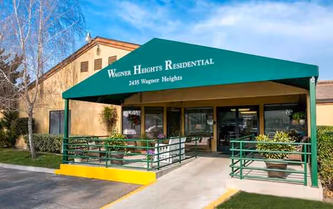 Front entrance of Wagner Heights Residential, green canopy over doorway and ramp.