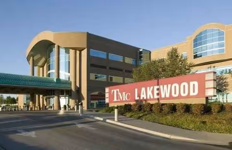 Exterior view of Truman Medical Center Lakewood Care Center entrance with a large sign.