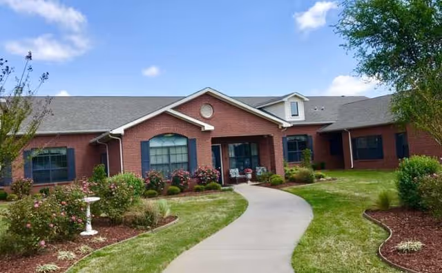 Bridgewater Memory Care exterior with brick facade, curved walkway, and landscaped entrance.