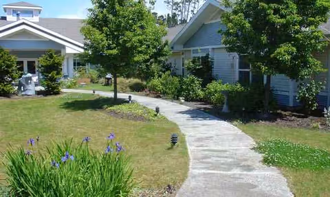 Exterior view of Golden Sands facility with a curved walkway and landscaped lawn.