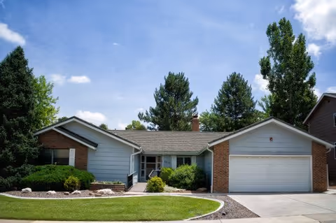 Front exterior of a single-story assisted living building with a two-car garage.