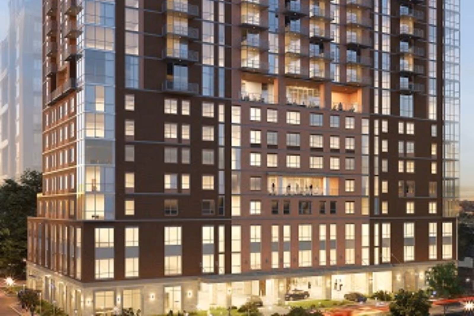 A tall mixed-use senior living building exterior with balconies and a lit ground floor.