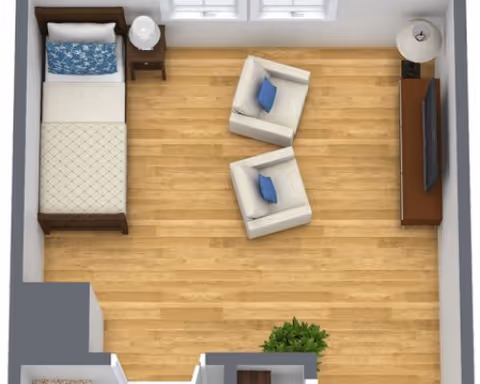 Top-down view of a small room with a single bed on the left side, two armchairs with blue cushions in the center, a TV on a stand against the right wall, a side table with a lamp next to the bed, and a floor lamp near the TV. The room has wooden flooring and a window on the top wall.