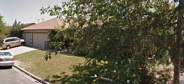 Exterior view of Abraham Rest Home, a single-story facility with a driveway and trees