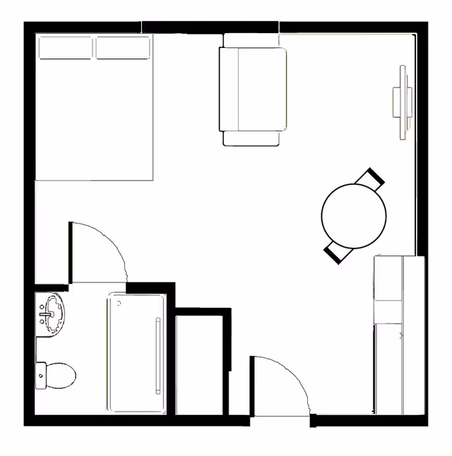 Black-and-white floor plan of a studio apartment showing a bed, sofa, round dining table, kitchenette and an adjacent bathroom.