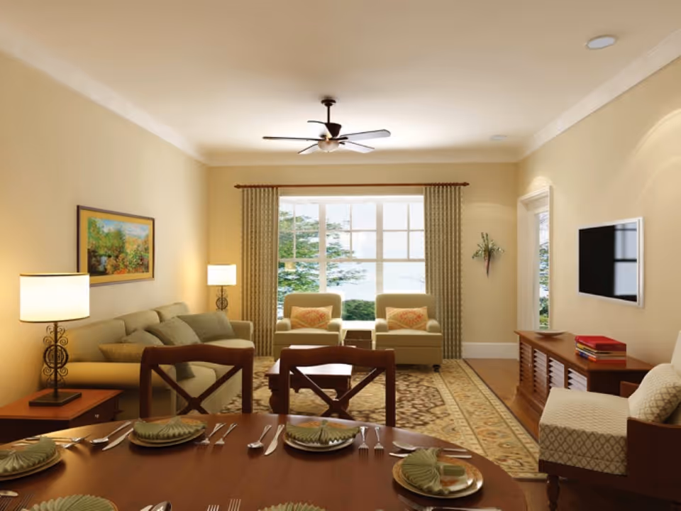 Open living and dining room with a set dining table in the foreground, sofa and armchairs facing a large window and wall-mounted TV.
