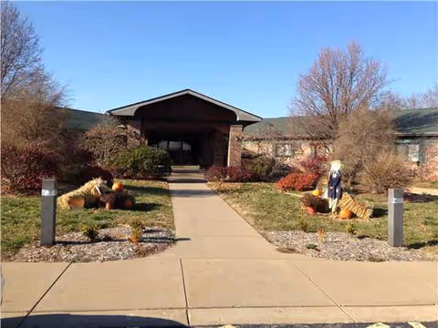 The front entrance to St Francois Manor with pumpkins and fall landscaping.