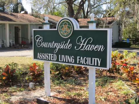 A green Countryside Haven sign in front of an assisted living facility building.