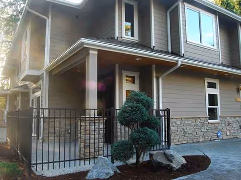 Front exterior of Abundant Life Lynnwood facility with a gated entrance and landscaped walkway.
