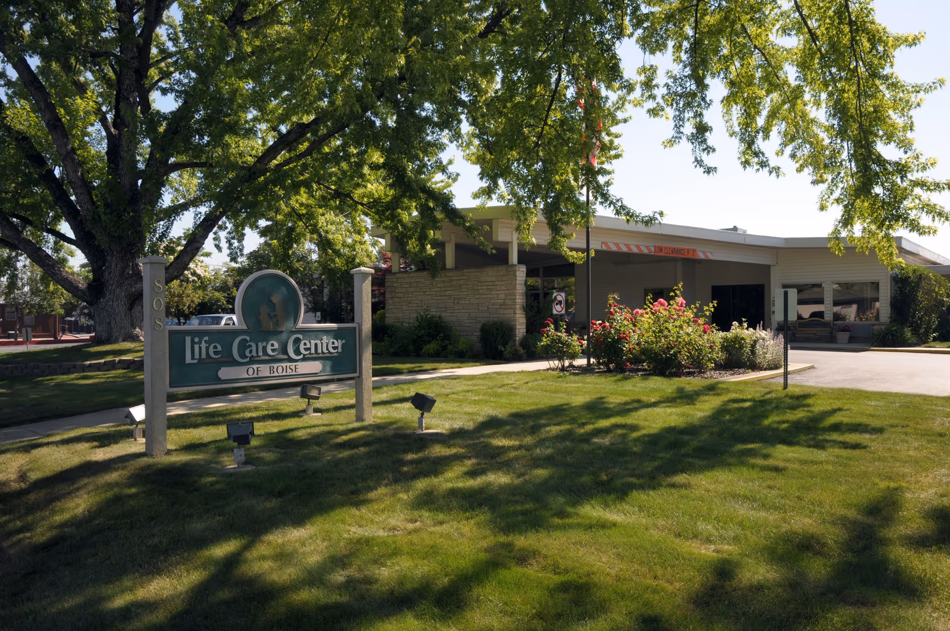 Front exterior of the Life Care Center of Boise with its sign, lawn, trees, and entrance visible.