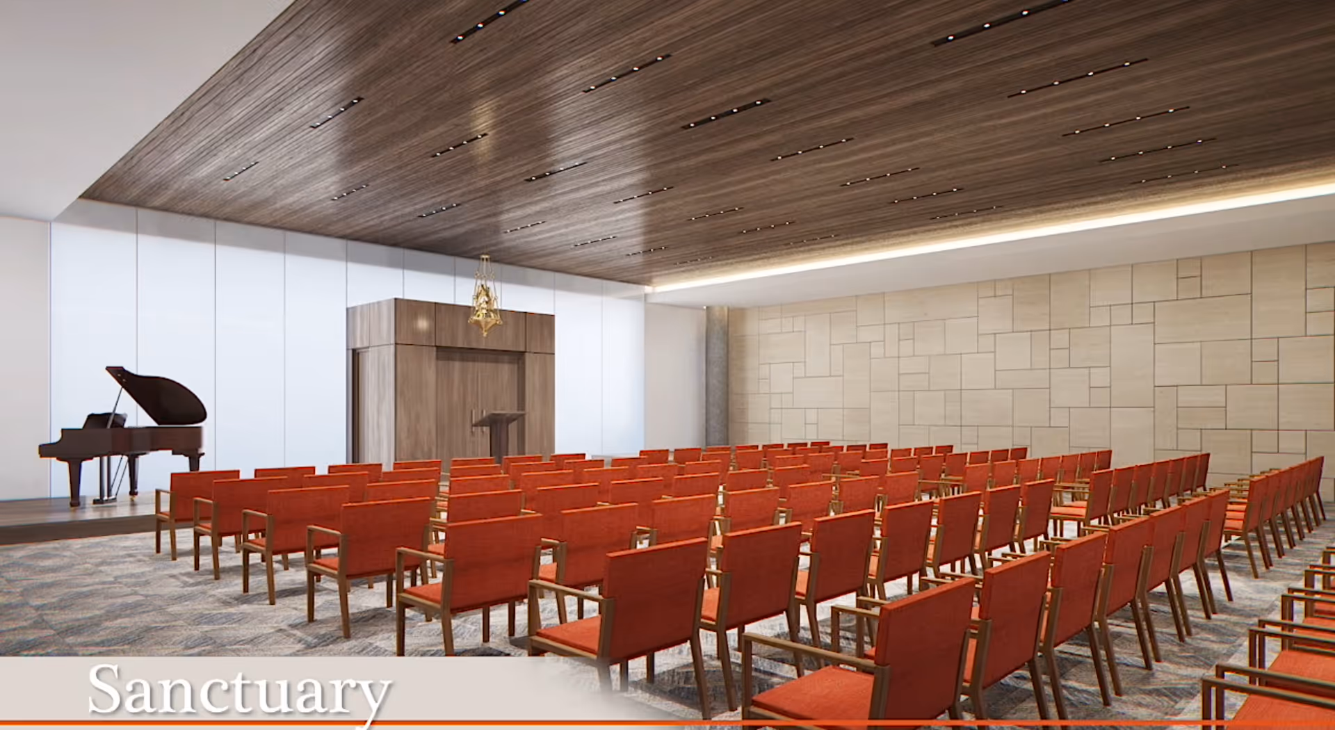 A modern sanctuary room with rows of red cushioned chairs facing a wooden podium and a grand piano on a raised platform. The ceiling has wooden paneling with recessed lighting, and the walls are light-colored with a geometric pattern.