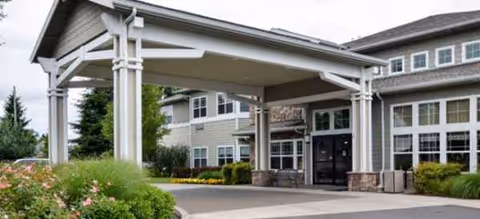 Meadowlark Senior Living front entrance with covered canopy and landscaped surroundings.
