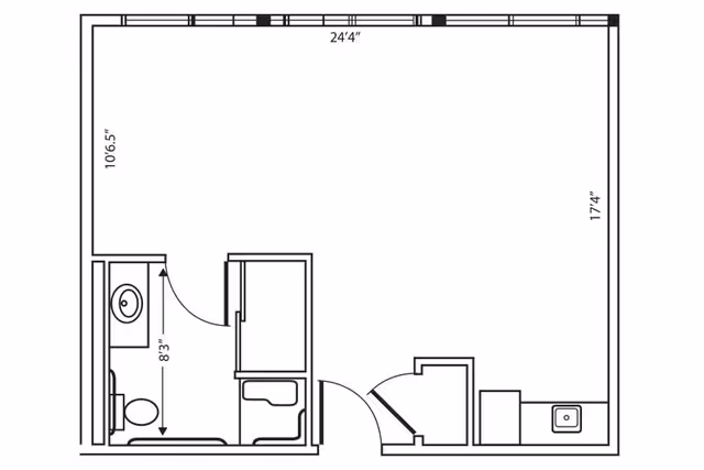 Architectural floor plan of a single room layout with a bathroom, closet, and kitchenette area. The room measures 24 feet 4 inches by 17 feet 4 inches. The bathroom includes a toilet and sink, and there is a small closet next to the entrance. The kitchenette has a sink and counter space.