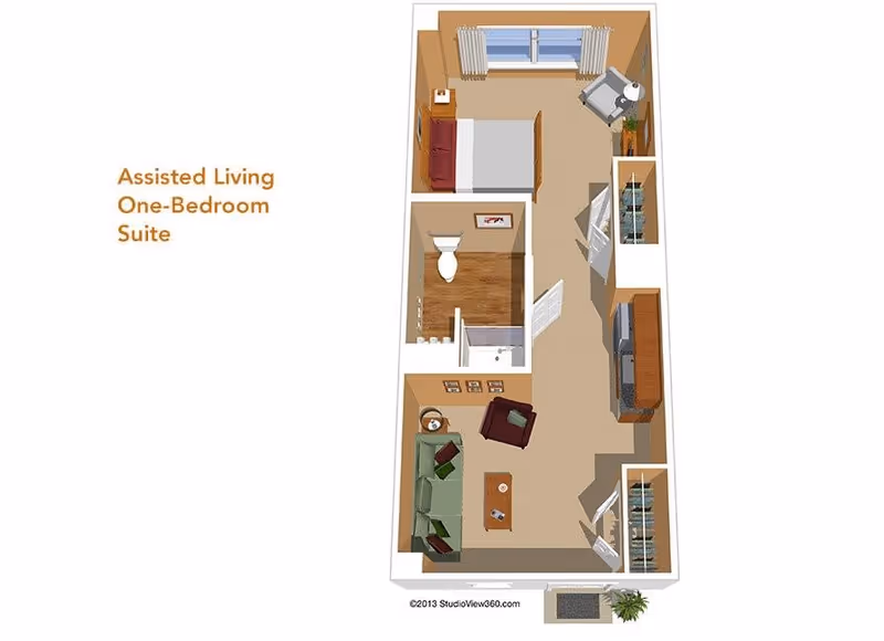 Floor plan of an assisted living one-bedroom suite showing a bedroom with a bed and chair, a bathroom with a toilet and shower, and a living room area with a sofa, armchair, coffee table, and TV stand.