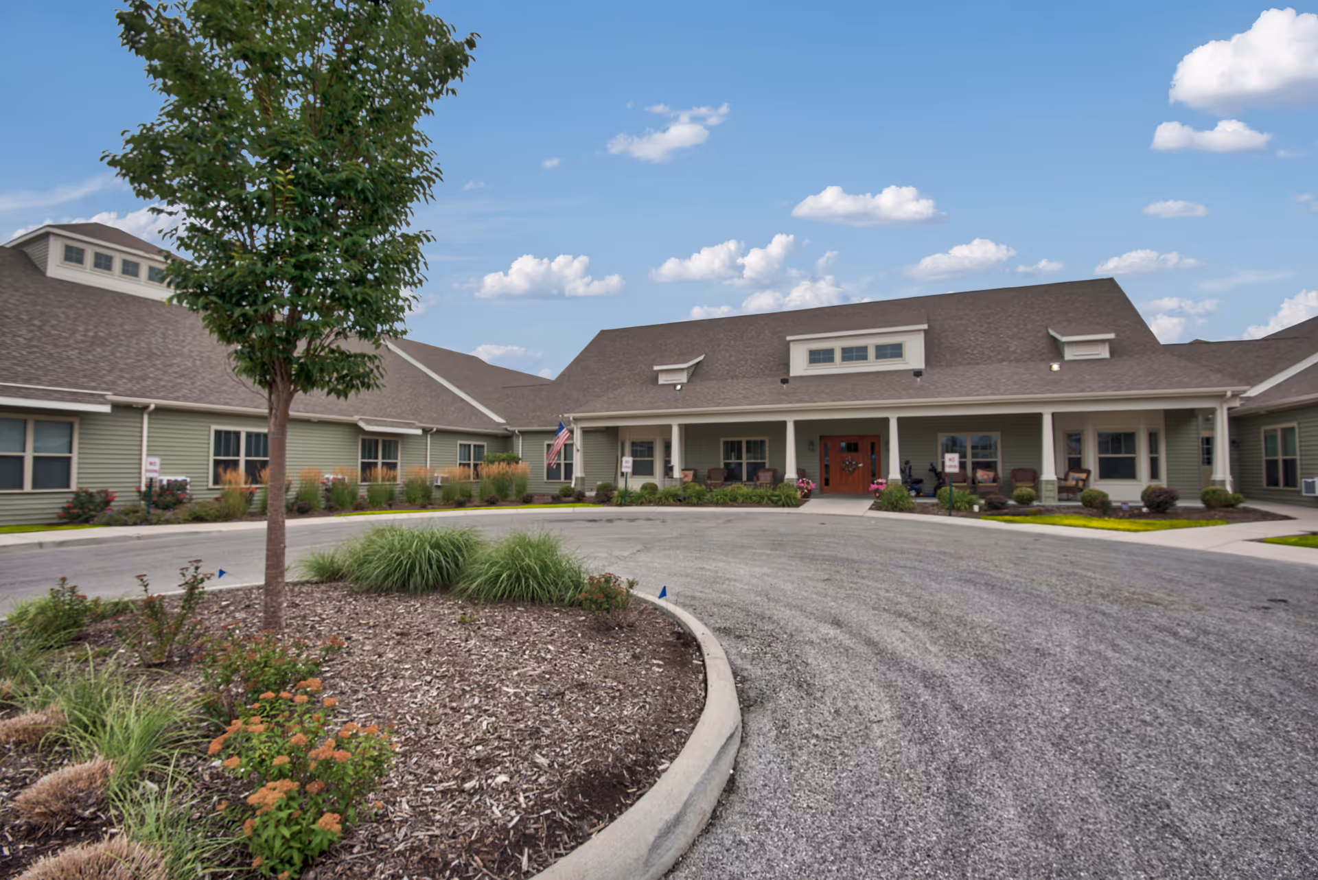 Front exterior of a Landings of Oregon senior living facility with a circular driveway.