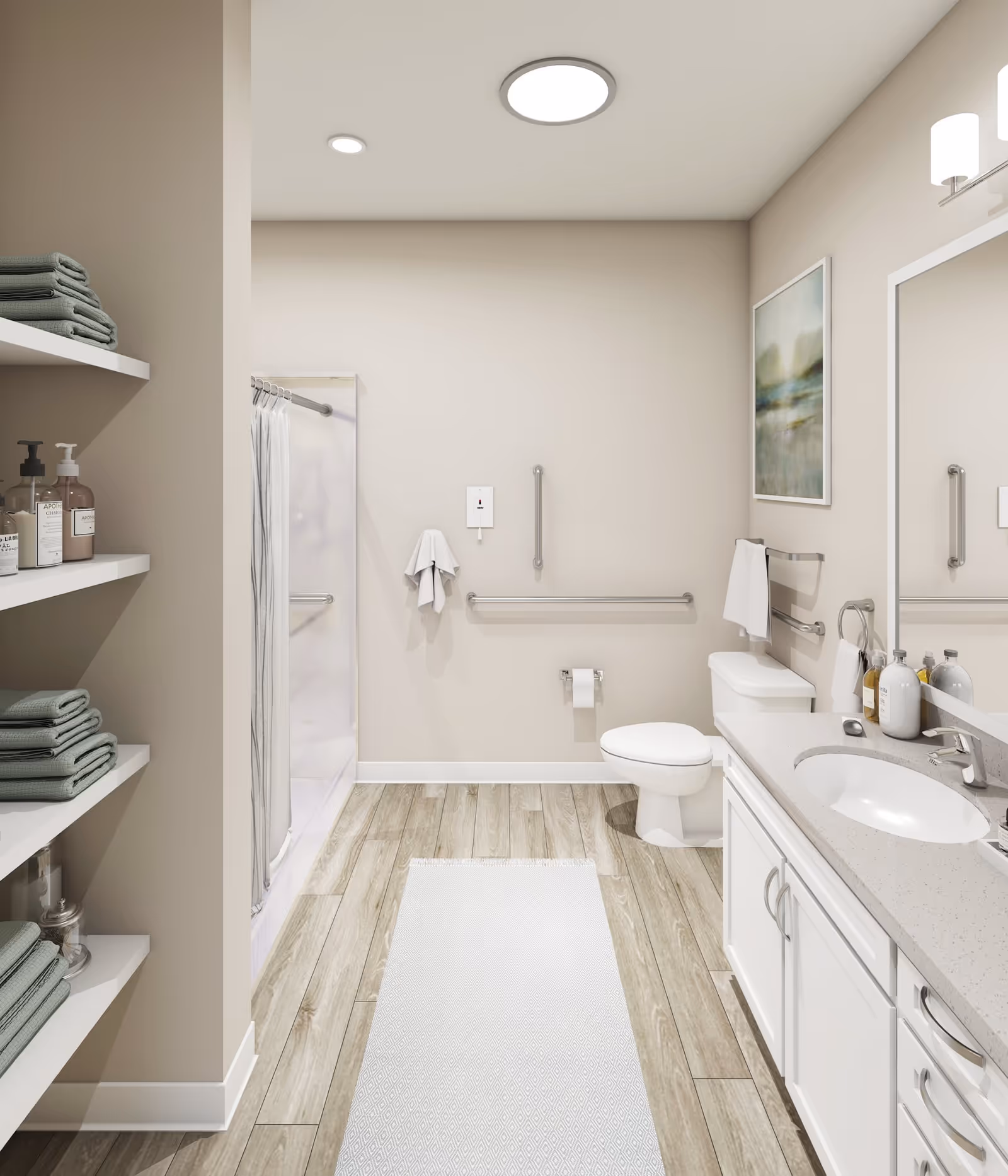 A clean and modern bathroom with light beige walls and wood-look tile flooring. The room features a white toilet with grab bars on the wall, a white vanity with a sink and countertop holding soap dispensers, a large mirror above the sink, and a shower with a curtain on the left side. Open shelves on the left hold neatly folded green towels and various bottles. A white rug runs along the floor in front of the vanity and toilet. The bathroom is well-lit with ceiling lights and a wall-mounted light fixture above the mirror. A framed landscape painting hangs on the wall above the toilet.
