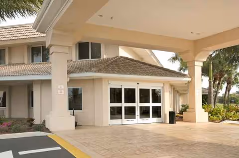 Exterior view of Life Care Center of Punta Gorda entrance with glass doors