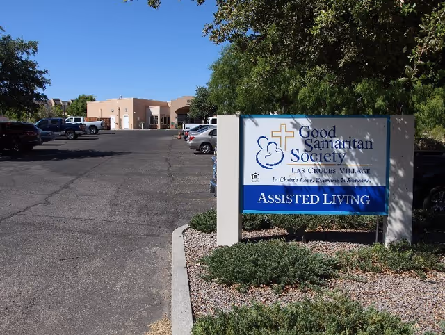 Parking lot leading to a low-rise assisted living building with a Good Samaritan Society 'Assisted Living' sign in the foreground.