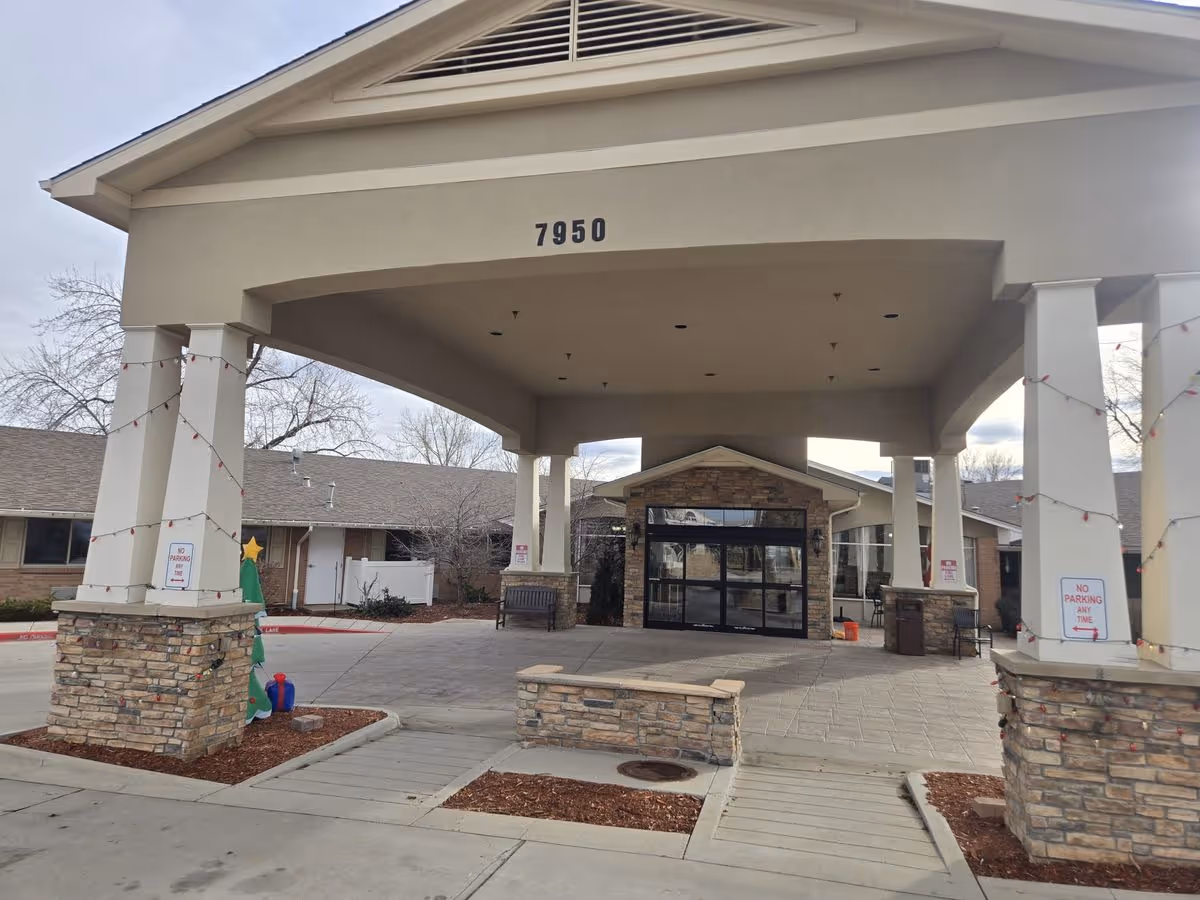 Covered entrance porte-cochere and main doors of Villa Manor Care Center with the address number 7950 displayed above.