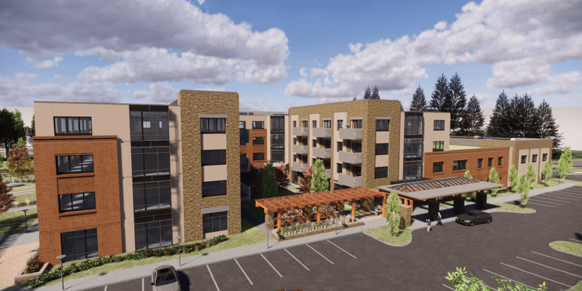 Exterior view of a modern multi-story senior living facility named Eagleview Landing, featuring a combination of brick and stone facade with large windows, a covered entrance with a pergola, surrounding greenery, and a parking lot in front.