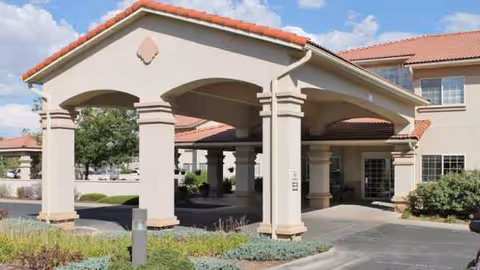 Entrance with a covered porte-cochere at The Bridge at Farmington senior living campus.