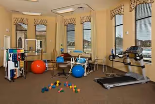 Interior senior fitness room with treadmills, exercise balls, and weights.