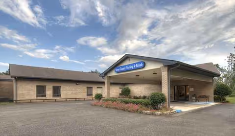 Stone County Rehabilitation & Nursing Center exterior with a covered entrance and shrubs.
