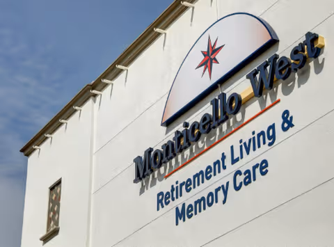 Exterior wall showing the Monticello West sign and logo with the words 'Retirement Living & Memory Care'.