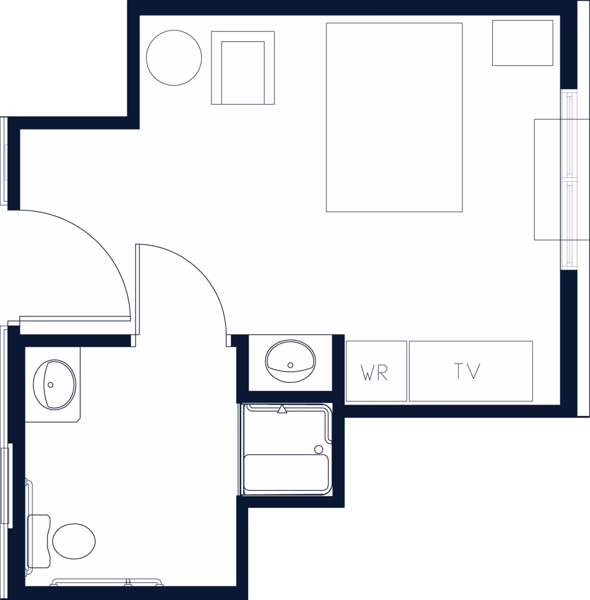 Floor plan of a studio unit showing a sleeping area with bed and TV/wardrobe, plus an adjacent bathroom with sink, toilet, and shower.