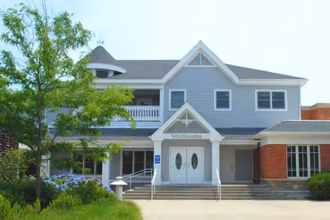 Front view of Windemere Nursing and Rehab Center on Martha's Vineyard, blue two-story building.