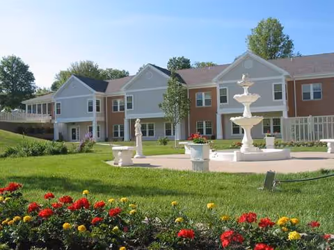 Cottage Grove Place exterior with a central fountain and manicured lawn courtyard.