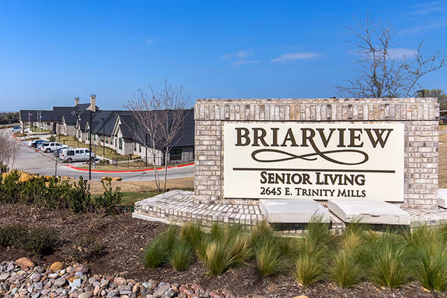 Exterior view of the Briarview sign with landscaped surroundings, showcasing the entrance to the facility.