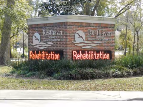 Brick entry sign for Resthaven Nursing & Rehabilitation Center with red digital rehabilitation displays.