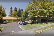 Exterior view of Parkview Christian Retirement Community with parked cars, trees, and front entrance.