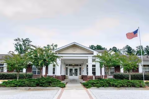 Front view of Summer Village Camellia Place entrance with flag