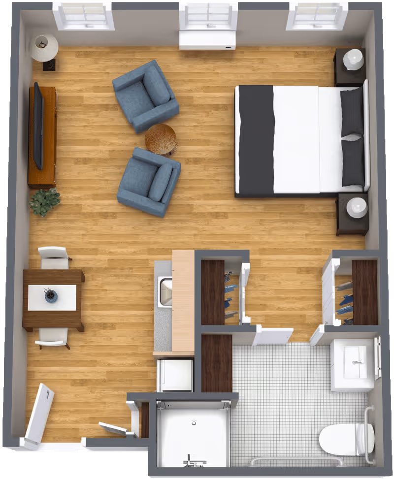 Top-down view of a studio apartment floor plan featuring a bedroom area with a bed and two nightstands, a living area with two blue armchairs and a TV, a small dining table with two chairs, a kitchenette with a sink and appliances, and a bathroom with a shower, toilet, and sink.