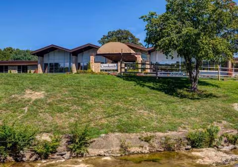 Exterior view of Creekside Center for Rehabilitation & Healing beside a grassy hill