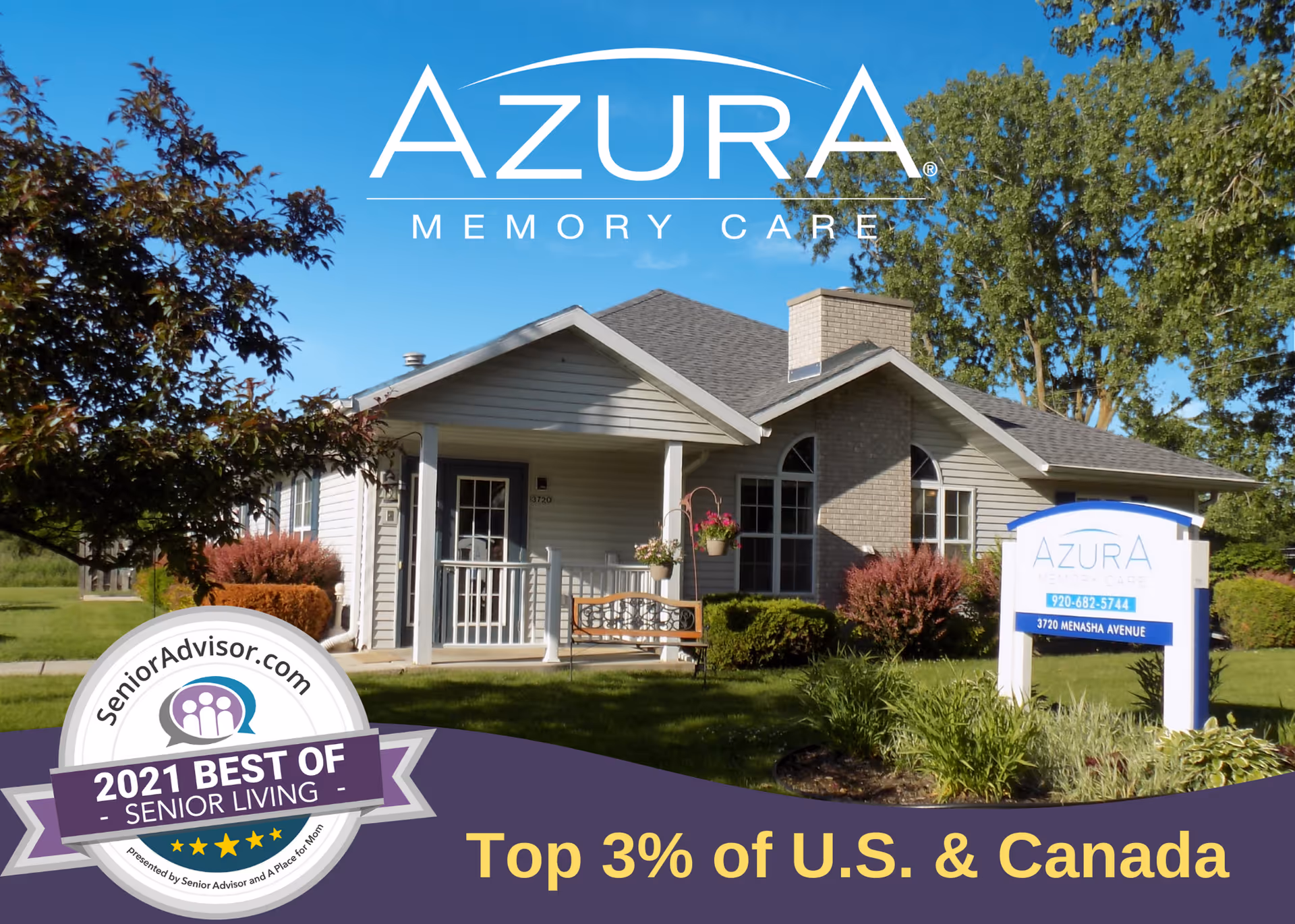 Exterior view of Azura Memory Care of Manitowoc, a single-story building with a porch, surrounded by green grass, bushes, and trees under a clear blue sky. There is a sign in front displaying the facility's name, phone number, and address. A badge in the bottom left corner indicates the facility was awarded '2021 Best of Senior Living' by SeniorAdvisor.com.