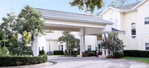 Exterior view of Brookdale Ormond Beach entrance with covered driveway and landscaping.
