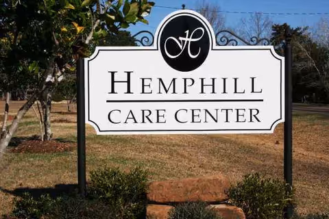 Large Hemphill Care Center sign in front yard with trees.