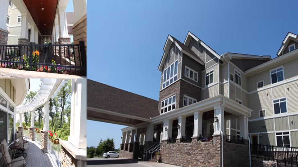 Collage of three images showing exterior views of a senior living facility. The largest image shows a multi-story building with stone and siding exterior, large windows, and a covered entrance supported by white columns. The top-left image shows a covered walkway with a wooden ceiling, stone pillars, and a black metal fence with flowers planted along it. The bottom-left image shows a balcony or patio area with white railings, stone pillars, outdoor seating, and flower boxes, overlooking a green wooded area.