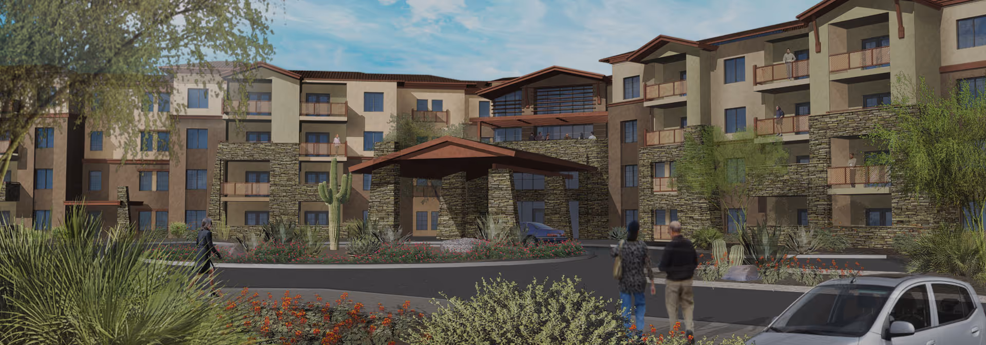 Front exterior of a multi-story residential building with balconies, a covered entrance, desert landscaping, and a car in the driveway.